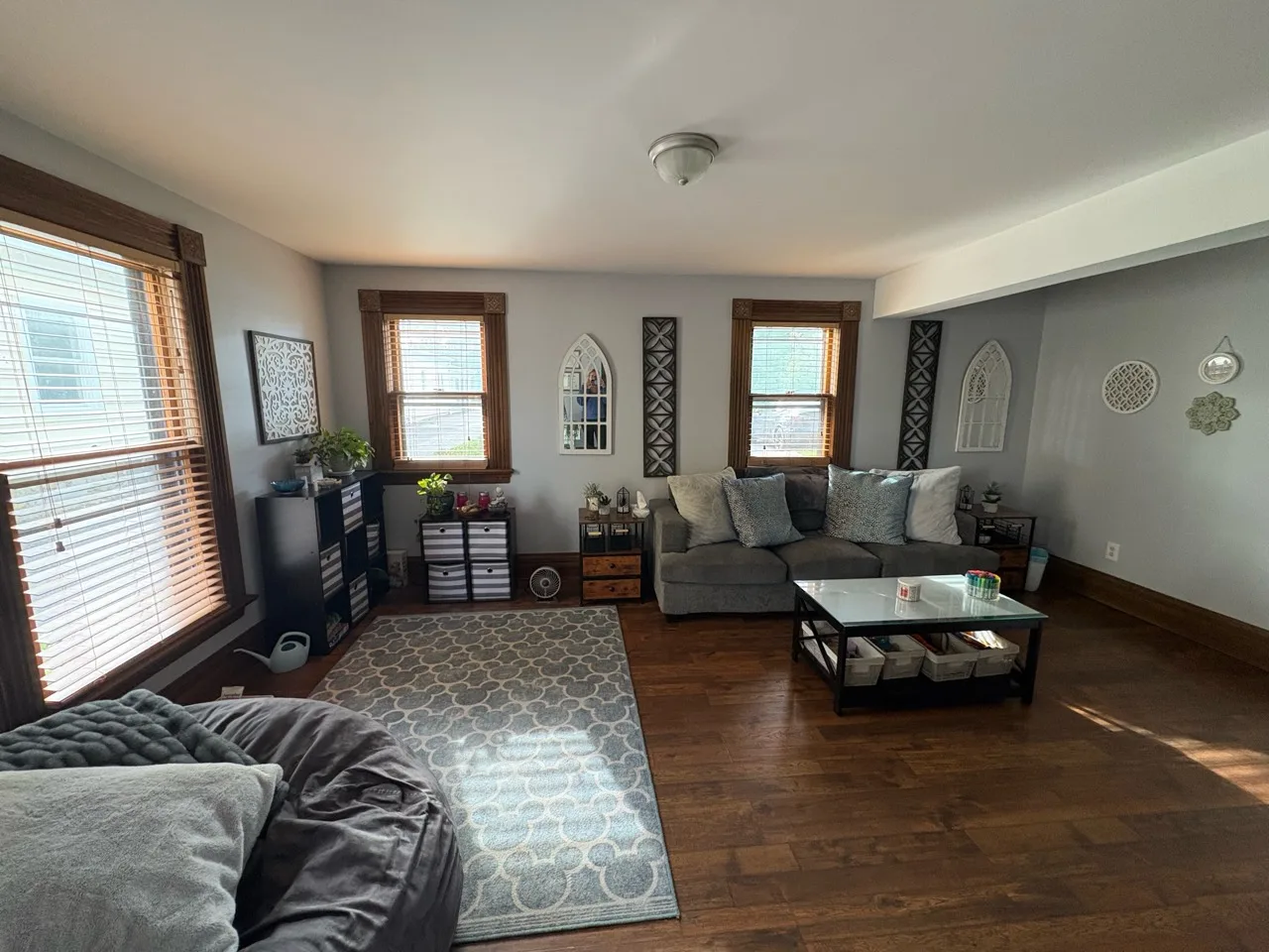 Therapy room with a couch, windows, and a glass coffee table